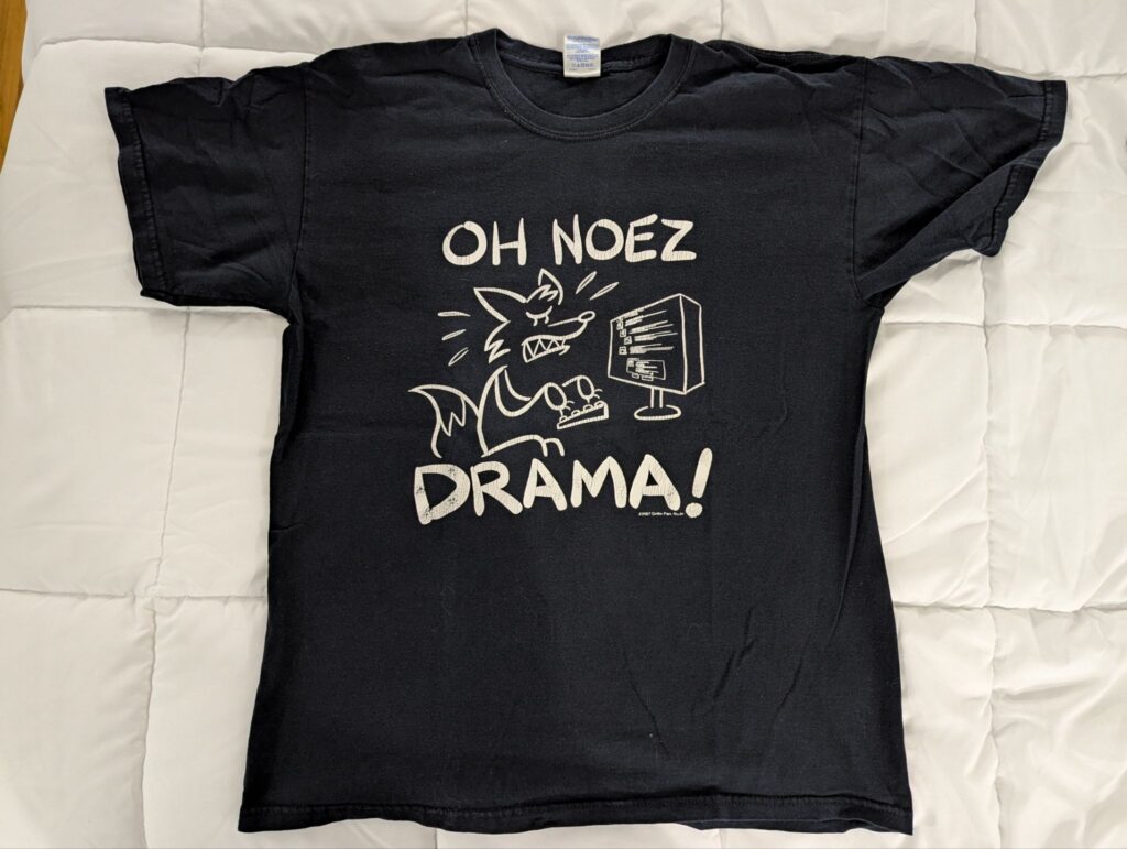A black T-shirt with an image of a fox angrily typing on a keyboard. "Oh Noez Drama!" reads the text.